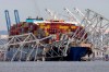 FILE - The cargo ship Dali is stuck under part of the Francis Scott Key Bridge after the ship hit the bridge, March 26, 2024, as seen from Pasadena, Md. (AP Photo/Mark Schiefelbein, File)