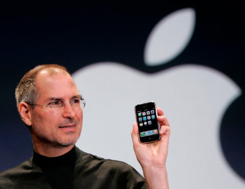 FILE - Apple CEO Steve Jobs holds up an Apple iPhone at the MacWorld Conference in San Francisco on Jan. 9, 2007. (AP Photo/Paul Sakuma, File)