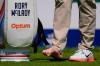 Rory McIlroy, of Northern Ireland, attends to his right foot on the fourth tee during a PGA Championship golf tournament practice round at Aronimink Golf Club, Tuesday, May 12, 2026, in Newtown Square, PA. (AP Photo/Matt Slocum)