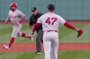 Boston Red Sox pitcher Jovani Moran (47) watches Philadelphia Phillies designated hitter Kyle Schwarber rounds the bases on a solo home run during the first inning of a baseball game, Tuesday, May 12, 2026, in Boston. (AP Photo/Charles Krupa)