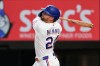 Texas Rangers' Brandon Nimmo follows through on triple in the fifth inning of a baseball game against the Arizona Diamondbacks Tuesday, May 12, 2026, in Arlington, Texas. (AP Photo/Tony Gutierrez)