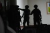 Philippine troopers exchange fire along a hallway at the Philippine Senate in Pasay, Philippines on Wednesday May 13, 2026. (AP Photo/Aaron Favila)