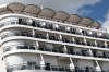 Passengers stand aboard the British cruise ship Ambition, as French authorities have ordered 1,700 passengers and crew to stay on board due to a gastrointestinal illness outbreak, in Bordeaux, southwestern France, Wednesday, May 13, 2026. (AP Photo/Caroline Blumberg)