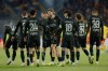 PSG's players celebrate after Khvicha Kvaratskhelia, unseen, scored the opening goal during the French League One soccer match between Lens and Paris Saint Germain, in Lens, northern France, Wednesday, May 13, 2026. (AP Photo/Jean-Francois Badias)