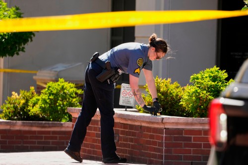 A Sheriff's deputy investigates a shooting scene outside the Montgomery County Courthouse, Wednesday, May 13, 2026, in Clarksville, Tenn. (AP Photo/George Walker IV)