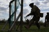 In this photo provided by Ukraine's 65th Mechanized Brigade press service, recruits practice military skills at a training ground near the frontline in the Zaporizhzhia region, Ukraine, Wednesday, April 29, 2026. (Andriy Andriyenko/Ukraine's 65th Mechanized Brigade via AP)