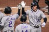 Colorado Rockies' Mickey Moniak (22) is greeted by Tyler Freeman (2) and Ezequiel Tovar (14) as he returns to the dugout after hitting a three-run home run off Pittsburgh Pirates pitcher Mitch Keller during the fifth inning of a baseball game in Pittsburgh, Wednesday, May 13, 2026. (AP Photo/Gene J. Puskar)