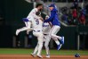 Texas Rangers' Ezequiel Duran, left, Danny Jansen (9) Sam Haggerty, rear, and MacKenzie Gore, right, celebrate Jansen's run-scoring single in the ninth inning of a baseball game against the Arizona Diamondbacks Wednesday, May 13, 2026, in Arlington, Texas. (AP Photo/Tony Gutierrez)