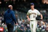Milwaukee Brewers' Jacob Misiorowski, right, talks with a trainer before the eighth inning of a baseball game against the San Diego Padres, Wednesday, May 13, 2026, in Milwaukee. (AP Photo/Aaron Gash)