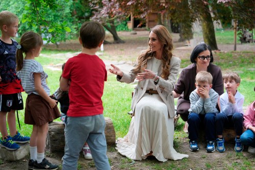 Britain's Kate, Princess of Wales sits with children during her visits the Salvador Allende preschool to observe how nature-based learning is embedded within the Reggio Emilia approach, part of a two-day trip, in Reggio Emilia, Italy, Thursday, May 14, 2026. (AP Photo/Antonio Calanni, Pool)
