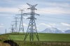 Power transmission lines are seen with the Rocky Mountains in the background near Pincher Creek, Alta., Thursday, June 6, 2024. THE CANADIAN PRESS/Jeff McIntosh