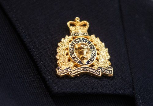 An RCMP collar tab pin is seen in Edmonton, Wednesday, Feb. 5, 2025. THE CANADIAN PRESS/Jason Franson