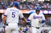 Texas Rangers' Corey Seager (5) and Joc Pederson, right, celebrate Pederson's solo home run in the first inning of a baseball game against the Arizona Diamondbacks Tuesday, May 12, 2026, in Arlington, Texas. (AP Photo/Tony Gutierrez)