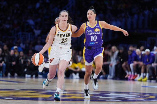 Los Angeles Sparks guard Kelsey Plum (10) pressures Indiana Fever guard Caitlin Clark (22) during the first half of a WNBA basketball game Wednesday, May 13, 2026, in Los Angeles. (AP Photo/Jae C. Hong)