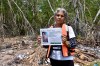 Alicia Santos Torres, from Cuba, shows a sign of her missing son Jorge Alejandro Lozada in San Jose Hueyate, Chiapas state, Mexico, Saturday, May 9, 2026, during a search for migrants who vanished in late 2024 along a maritime smuggling route to the U.S. (AP Photo/Edgar H. Clemente)