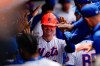 New York Mets' A.J. Ewing (9) celebrates in the dugout with teammates after hitting a home run during the third inning of a baseball game against the Detroit Tigers, Thursday, May 14, 2026, in New York. (AP Photo/Yuki Iwamura)