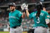 Seattle Mariners' Luke Raley, left, celebrates with J.P. Crawford after hitting a home run during the first inning of a baseball game against the Houston Astros in Houston, Thursday, May 14, 2026. (AP Photo/Ashley Landis)