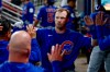 Chicago Cubs' Ian Happ is greeted in the dugout after scoring against the Atlanta Braves during the sixth inning of a baseball game, Thursday, May 14, 2026, in Atlanta. (AP Photo/Erik S. Lesser)