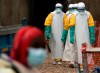 FILE - Health workers dressed in protective gear begin their shift at an Ebola treatment center in Beni, Congo, July 16, 2019. (AP Photo/Jerome Delay, File)