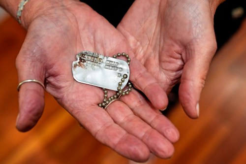FILE- Diane Christie holds a recovered dog tag belonging to her uncle, World War II U.S. Army Air Forces 2nd Lt. Thomas Kelly, Friday, May 23, 2025, in San Leandro, Calif. (AP Photo/Godofredo A. Vásquez)