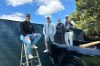 Golf fans pose for a photo while watching the PGA Championship golf tournament from pickup trucks and ladders from neighborhood homes outside Aronimink Golf Club, Friday, May 15, 2026 in Newtown Square, Pa. (AP Photo/Dan Gelston)