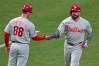 Philadelphia Phillies' Kyle Schwarber, right, rounds third base to greetings from third base coach Anth Contreras (88) after hitting a two-run home run off Pittsburgh Pirates pitcher Braxton Ashcraft during the fifth inning of a baseball game in Pittsburgh, Friday, May 15, 2026. (AP Photo/Gene J. Puskar)