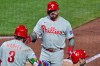 Philadelphia Phillies' Kyle Schwarber, top, is greeted by Bryce Harper (3) as he crosses home plate after hitting a two-run home run off Pittsburgh Pirates pitcher Mason Montgomery during the seventh inning of a baseball game in Pittsburgh, Friday, May 15, 2026. (AP Photo/Gene J. Puskar)