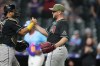 Arizona Diamondbacks catcher Gabriel Moreno, left, congratulates starting pitcher Merrill Kelly, right, after Kelly threw a complete baseball game to defeat the Colorado Rockies, Friday, May 15, 2026, in Denver. (AP Photo/David Zalubowski)