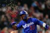 Los Angeles Dodgers' Teoscar Hernández has seeds thrown at him after hitting a two-run home run during the sixth inning of a baseball game against the Los Angeles Angels, Friday, May 15, 2026, in Anaheim, Calif. (AP Photo/Mark J. Terrill)