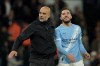 Manchester City's head coach Pep Guardiola, left, celebrates with Manchester City's Rayan Cherki at the end of the English Premier League soccer match between Manchester City and Crystal Palace in Manchester, England, Wednesday, May 13, 2026. (AP Photo/Ian Hodgson)