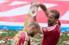 Bayern's Harry Kane, pours beer on Bayern's Joshua Kimmich as they celebrate the Bundesliga title at the end of the soccer match between Bayern and FC Cologne in Munich, Germany, Saturday, May 16, 2026. (AP Photo/Matthias Schrader)