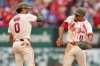 St. Louis Cardinals' Masyn Winn (0) and Victor Scott II (11) celebrate a victory over the Kansas City Royals in a baseball game Saturday, May 16, 2026, in St. Louis. (AP Photo/Jeff Roberson)