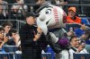 Actor/filmmaker Tom Hanks, center left, stands with Mr. Met, center right, during the sixth inning of a baseball game between the New York Mets and the New York Yankees, Saturday, May 16, 2026, in New York. (AP Photo/Yuki Iwamura)