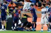 Houston Dynamo FC midfielder Jose Artur (6) fans the air with a towel over defender Diadie Samassekou, center on ground, as he is attended to by medical personnel after an apparent injury during the first half of an MLS soccer match against Vancouver Whitecaps FC, Saturday, May 16, 2026, in Houston. (AP Photo/Michael Wyke)