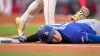 Los Angeles Dodgers' Shohei Ohtani, below, dives back to first under the tag of Los Angeles Angels first baseman Nolan Schanuel during the third inning of a baseball game Saturday, May 16, 2026, in Anaheim, Calif. (AP Photo/Mark J. Terrill)
