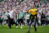 Celtic fans invade the pitch at full time following following the Scottish Premiership soccer match against Heart of Midlothian in Glasgow, Scotland, Saturday, May 16, 2026. (Andrew Milligan/PA via AP)