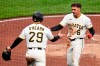 Pittsburgh Pirates' Konnor Griffin (6) and Ryan O'Hearn celebrate after scoring on a single by Endy Rodriguez off Colorado Rockies pitcher Chase Dollander during the third inning of a baseball game in Pittsburgh, Thursday, May 14, 2026. (AP Photo/Gene J. Puskar)