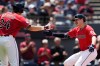 Cleveland Guardians' Kyle Manzardo, right, is congratulated by Chase DeLauter (24) after hitting a home run in the third inning of a baseball game against the Cincinnati Reds in Cleveland, Sunday, May 17, 2026. (AP Photo/Sue Ogrocki)