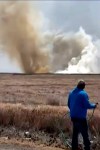This still image taken from video shows a plume of smoke rises above the plain near Mountain Home Air Force Base, Idaho, where two Navy jets collided at an air show on Sunday. (Lisa Van Horne via AP)