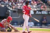 Cleveland Guardians' Angel Martínez watches his home run in front of Cincinnati Reds catcher Tyler Stephenson, left, in the seventh inning of a baseball game against the Cincinnati Reds in Cleveland, Sunday, May 17, 2026. (AP Photo/Sue Ogrocki)