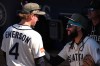 Seattle Mariners third baseman Colt Emerson (4) talks with shortstop J.P. Crawford, right, in the dugout before Emerson's major league debut against the San Diego Padres in a baseball game, Sunday, May 17, 2026, in Seattle. (AP Photo/Lindsey Wasson)