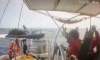 This grab from CCTV footage shows activists aboard a flotilla boat with their hands in the air as a boat approaches one of more than 50 vessels that departed from the port of Marmaris, Turkey, last week in what organizers of the Global Sumud Flotilla described as the final leg of their planned journey to Gaza's shores, in international waters Monday, May 18, 2026. (Global Sumud Flotilla via AP)