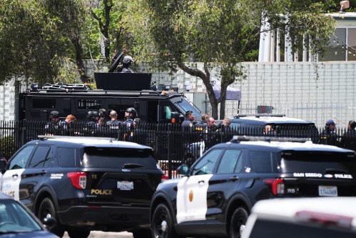 Police stage at the scene of a shooting outside the Islamic Center of San Diego Monday, May 18, 2026, in San Diego. (AP Photo/Gregory Bull)