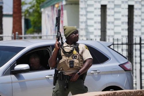 A sheriff's deputy stages at the scene of a shooting outside the Islamic Center of San Diego Monday, May 18, 2026, in San Diego. (AP Photo/Gregory Bull)