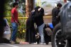 People embrace near the scene of a shooting outside the Islamic Center of San Diego Monday, May 18, 2026, in San Diego. (AP Photo/Gregory Bull)