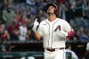 Arizona Diamondbacks' Nolan Arenado celebrates after hitting a grand slam against the San Francisco Giants in the first inning of a baseball game, Monday, May 18, 2026, in Phoenix. (AP Photo/Rick Scuteri)