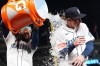 Seattle Mariners' Colt Emerson, right, is doused by teammate J.P. Crawford, left, to celebrate a win over the Chicago White Sox in a baseball game, Monday, May 18, 2026, in Seattle. (AP Photo/Lindsey Wasson)