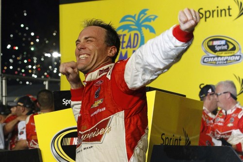 FILE - Kevin Harvick celebrates after winning the NASCAR Sprint Cup championship series auto race, Nov. 16, 2014, in Homestead, Fla. (AP Photo/Terry Renna, File)