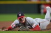 Washington Nationals third baseman Brady House dives in foul territory for a ground ball during the eighth inning of a baseball game against the Cincinnati Reds, Tuesday, May 12, 2026, in Cincinnati. (AP Photo/Kareem Elgazzar)