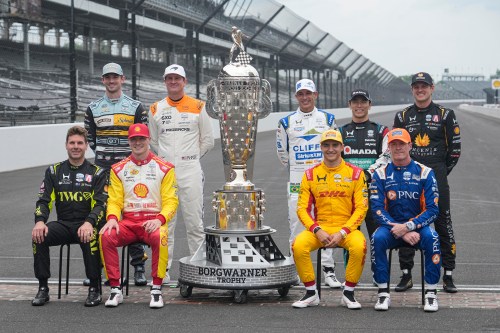 Former winners of the Indianapolis 500 auto race pose at the Indianapolis Motor Speedway in Indianapolis, Monday, May 18, 2026. Front row, left to right, Will Power, of Australia; Josef Newgarden; Alex Palou, of Spain; and Scott Dixon, of New Zealand. Second row: left to right, Alexander Rossi; Ryan Hunter-Reay; Helio Castroneves, of Brazil; Takuma Sato, of Japan; and Marcus Ericsson, of Sweden. (AP Photo/Michael Conroy)